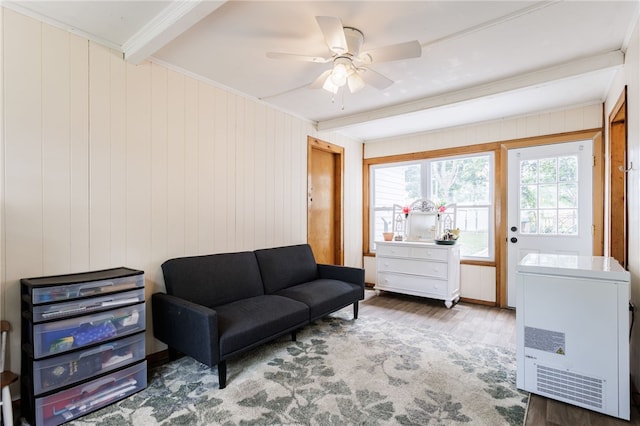 387 Brandon Rd, Irondequoit, NY 14622 - living area with wood finished floors, beam ceiling, a ceiling fan, wood walls, and ornamental molding