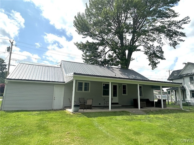 504 Allen Rd, Clay, NY 13212 - rear view of property featuring a lawn, a metal roof, and a patio area