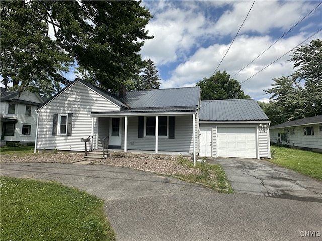 504 Allen Rd, Clay, NY 13212 - view of front of property featuring a garage, asphalt driveway, a metal roof, and covered porch
