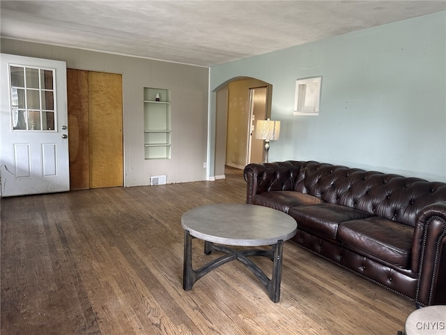 504 Allen Rd, Clay, NY 13212 - living room with wood finished floors, arched walkways, and built in shelves