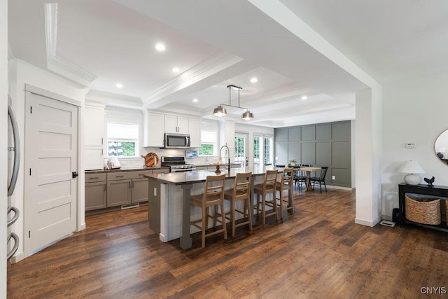 2178 Conley Rd, Sullivan, NY 13037 - kitchen featuring crown molding, stainless steel appliances, plenty of natural light, dark wood finished floors, and a kitchen bar