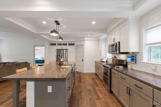2178 Conley Rd, Sullivan, NY 13037 - kitchen with appliances with stainless steel finishes, a breakfast bar area, decorative backsplash, ornamental molding, and dark wood-style floors