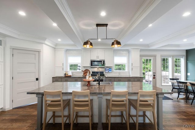 2178 Conley Rd, Sullivan, NY 13037 - kitchen with stainless steel microwave, a center island with sink, crown molding, decorative backsplash, and white cabinets