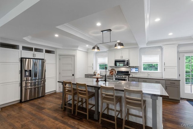 2178 Conley Rd, Sullivan, NY 13037 - kitchen with stainless steel appliances, crown molding, dark wood-style flooring, a breakfast bar area, and an island with sink