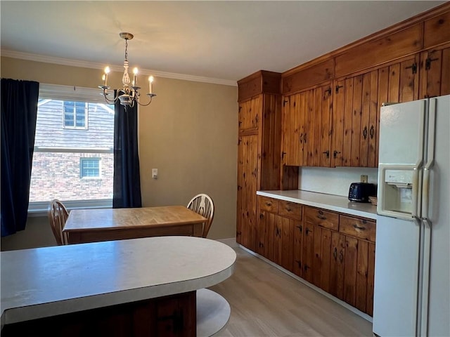 100 Curren Dr, Elmira, NY 14905 - kitchen featuring white fridge with ice dispenser, a chandelier, brown cabinetry, light countertops, and light wood finished floors