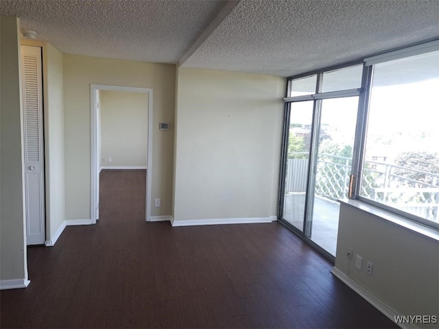 1088 Delaware Ave Unit 6C, Buffalo, NY 14209 - unfurnished room with a textured ceiling, dark wood-style floors, and expansive windows