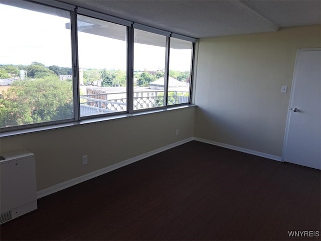 1088 Delaware Ave Unit 6C, Buffalo, NY 14209 - empty room featuring dark wood finished floors and baseboards
