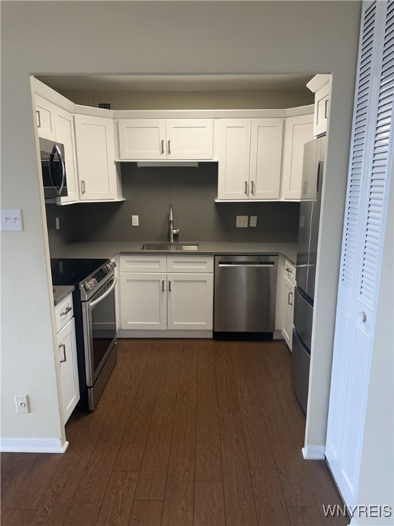 1088 Delaware Ave Unit 6C, Buffalo, NY 14209 - kitchen with stainless steel appliances, dark wood-style flooring, and white cabinetry