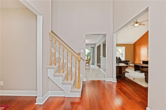 203 Torrey Pine Dr, Greece, NY 14612 - foyer with hardwood / wood-style flooring, stairs, a ceiling fan, and a high ceiling