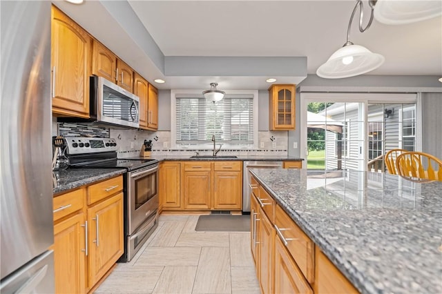 203 Torrey Pine Dr, Greece, NY 14612 - kitchen with appliances with stainless steel finishes, backsplash, dark stone counters, glass insert cabinets, and recessed lighting