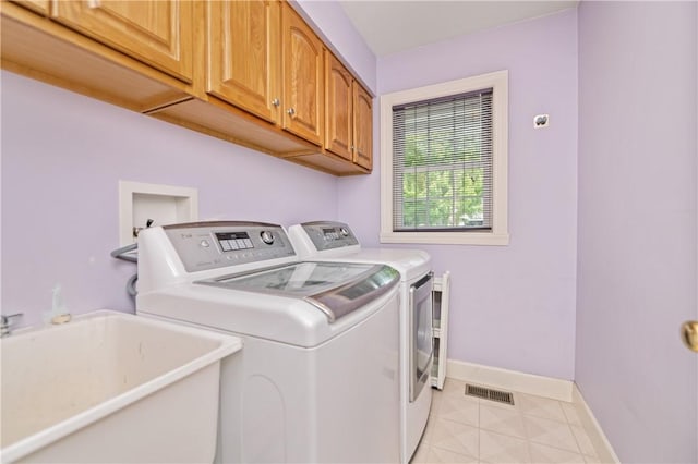 203 Torrey Pine Dr, Greece, NY 14612 - laundry area featuring washing machine and clothes dryer, cabinet space, and light tile patterned floors