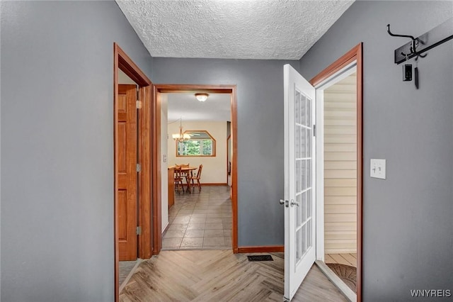 3735 County Road 34, Wirt, NY 14739 - hall with french doors, a chandelier, and a textured ceiling