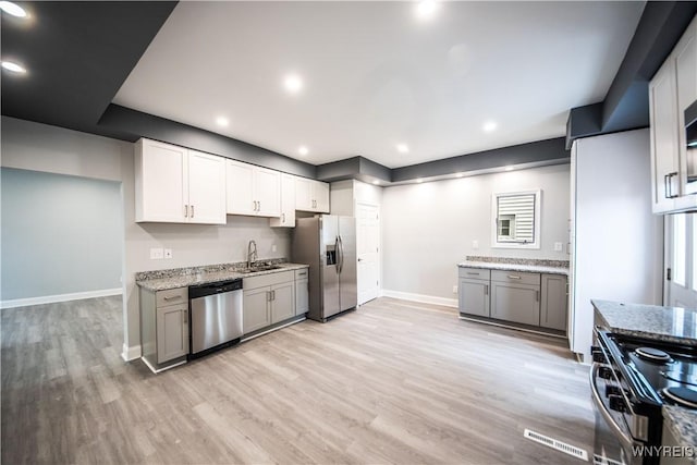 187 Lock St, Lockport-City, NY 14094 - kitchen with stainless steel appliances, light wood finished floors, light stone countertops, gray cabinets, and recessed lighting