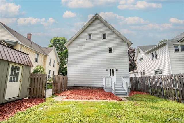 187 Lock St, Lockport-City, NY 14094 - rear view of house with a fenced backyard and a storage unit
