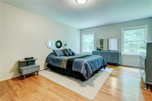 40 Little Glen Rd, Henrietta, NY 14534 - bedroom featuring light wood-style flooring and baseboards