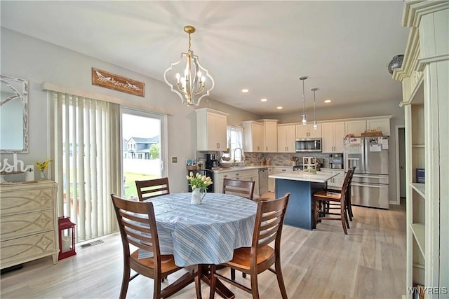 5472 Sycamore Ln, Hamburg, NY 14075 - dining room featuring light wood-style floors, a chandelier, and recessed lighting