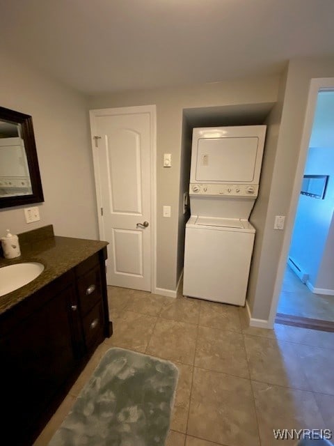 4192 Upson Point Rd, Starkey, NY 14837 - bathroom featuring stacked washer and clothes dryer, vanity, and tile patterned floors