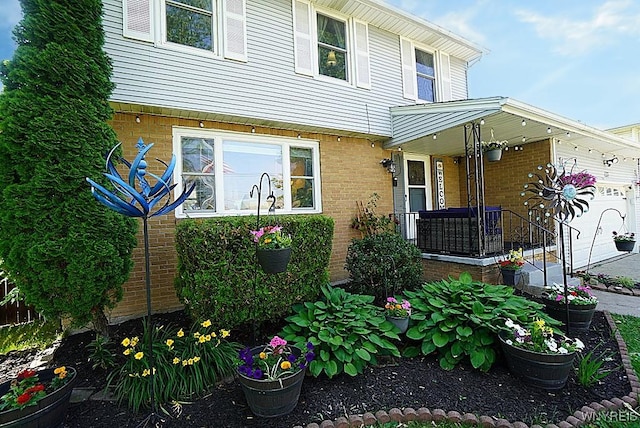 3042 Baseline Rd, Grand Island, NY 14072 - view of exterior entry featuring brick siding and a garage