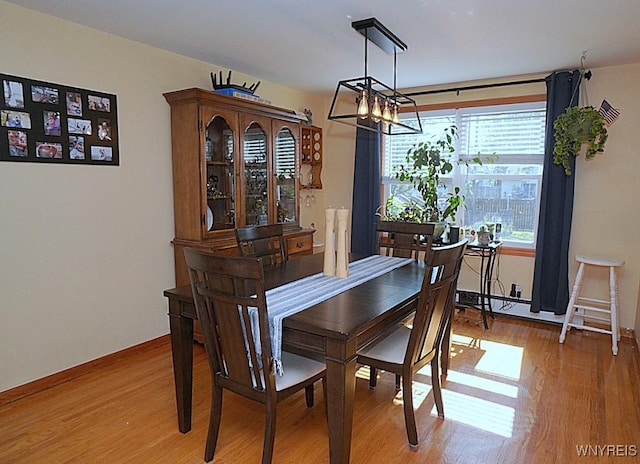 3042 Baseline Rd, Grand Island, NY 14072 - dining room with light wood-type flooring and a chandelier