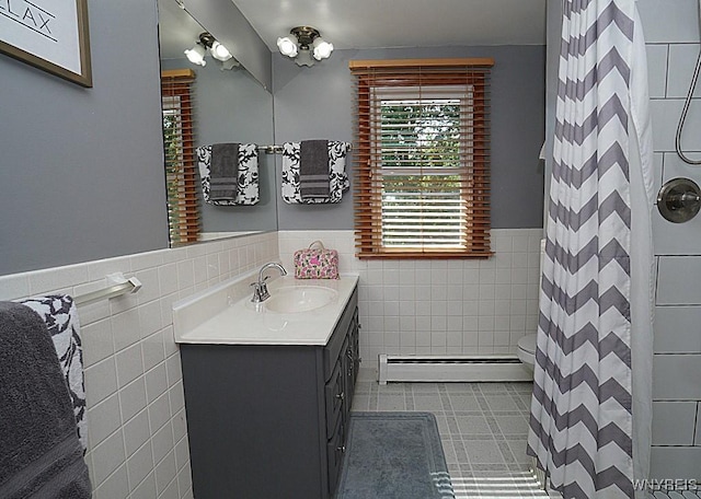 3042 Baseline Rd, Grand Island, NY 14072 - bathroom featuring a baseboard radiator, tile walls, vanity, a wainscoted wall, and a shower with curtain