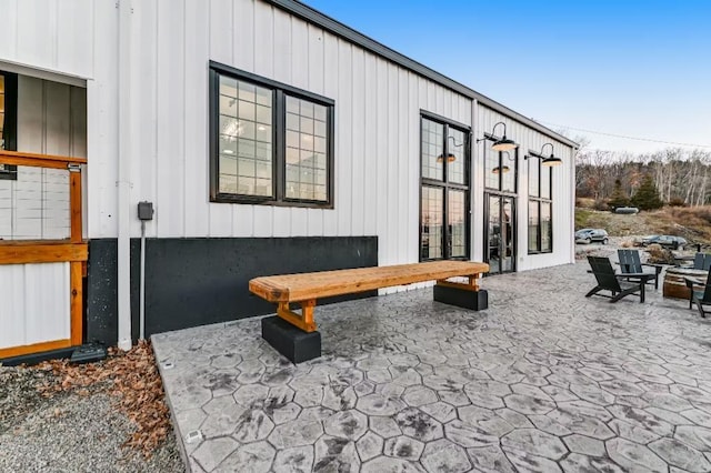 11059 Gold Seal Way, Urbana, NY 14840 - view of home's exterior featuring a patio area, an outdoor fire pit, board and batten siding, and french doors