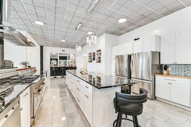 11059 Gold Seal Way, Urbana, NY 14840 - kitchen with appliances with stainless steel finishes, a kitchen island, and white cabinetry