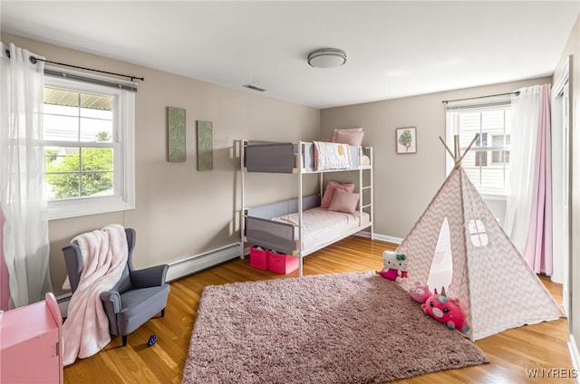 79 Hemlock Dr, West Seneca, NY 14224 - bedroom with baseboard heating and wood finished floors