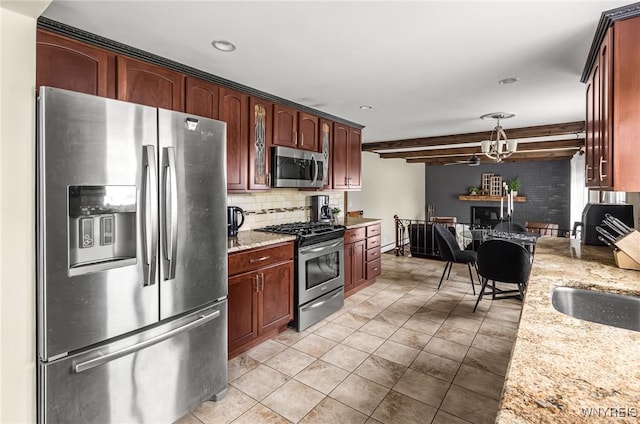 79 Hemlock Dr, West Seneca, NY 14224 - kitchen with appliances with stainless steel finishes, tasteful backsplash, light stone counters, light tile patterned flooring, and decorative light fixtures