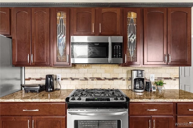 79 Hemlock Dr, West Seneca, NY 14224 - kitchen featuring appliances with stainless steel finishes, glass insert cabinets, tasteful backsplash, and light stone countertops