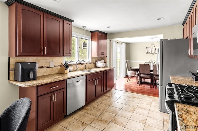 79 Hemlock Dr, West Seneca, NY 14224 - kitchen with dishwasher, stove, tasteful backsplash, light tile patterned flooring, and a chandelier