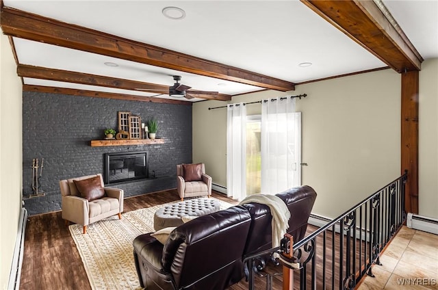 79 Hemlock Dr, West Seneca, NY 14224 - living room featuring a baseboard heating unit, beam ceiling, a fireplace, ceiling fan, and wood finished floors