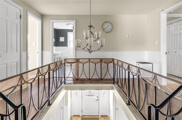 79 Hemlock Dr, West Seneca, NY 14224 - stairs featuring a chandelier and wainscoting