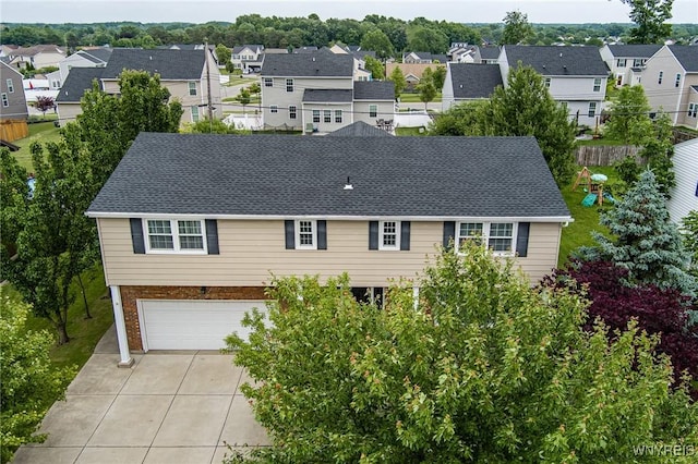 79 Hemlock Dr, West Seneca, NY 14224 - traditional-style home with a residential view, concrete driveway, an attached garage, roof with shingles, and brick siding