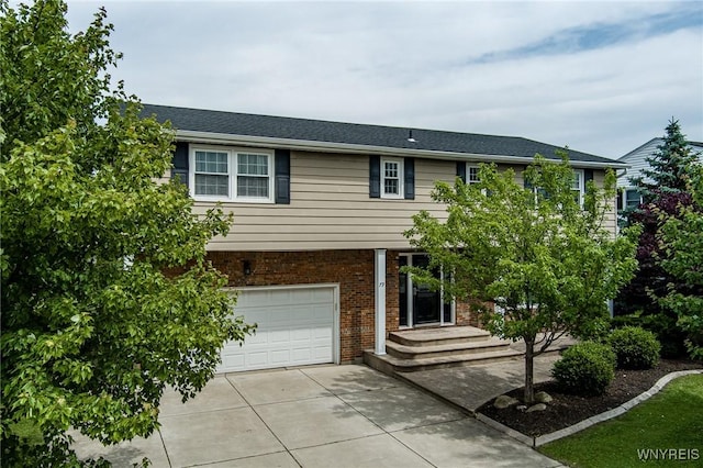 79 Hemlock Dr, West Seneca, NY 14224 - view of front of home featuring a garage, concrete driveway, and brick siding