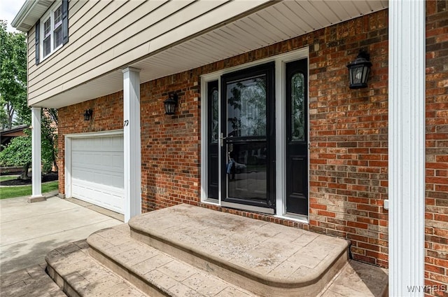 79 Hemlock Dr, West Seneca, NY 14224 - property entrance featuring brick siding, covered porch, driveway, and a garage