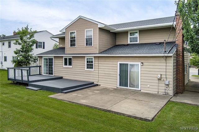 79 Hemlock Dr, West Seneca, NY 14224 - back of house featuring a lawn, a patio area, a wooden deck, a shingled roof, and a chimney