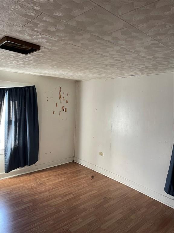 1123 Abbott St, Elmira-City, NY 14901 - empty room featuring wood finished floors and baseboards