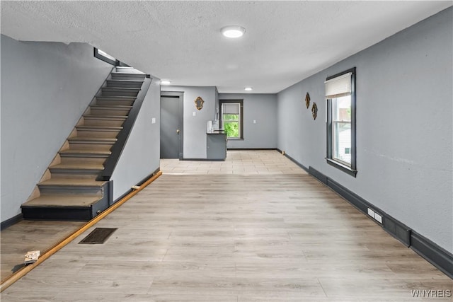 540 17th St, Niagara Falls, NY 14301 - unfurnished living room with stairs, wood finished floors, and a textured ceiling