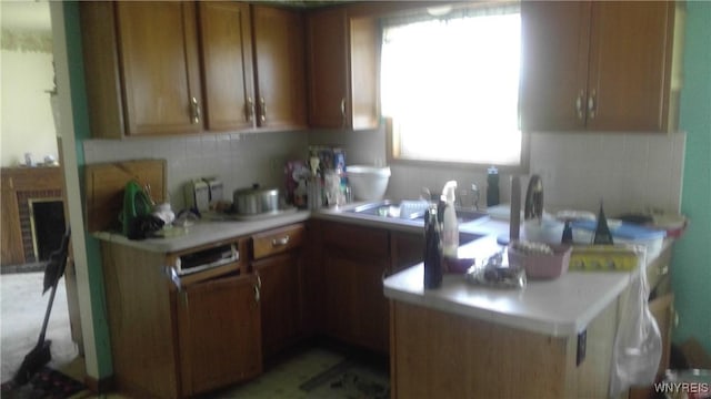 69 Holbrook St, Lackawanna, NY 14218 - kitchen with light countertops, tasteful backsplash, and brown cabinetry
