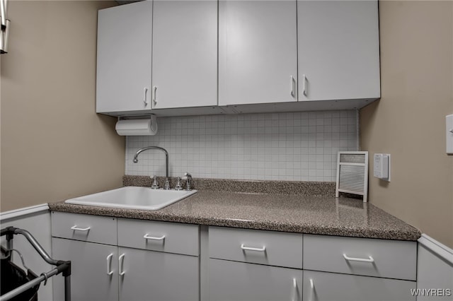 9210 Via Cimato Dr, Clarence, NY 14032 - kitchen with tasteful backsplash, dark countertops, and white cabinets