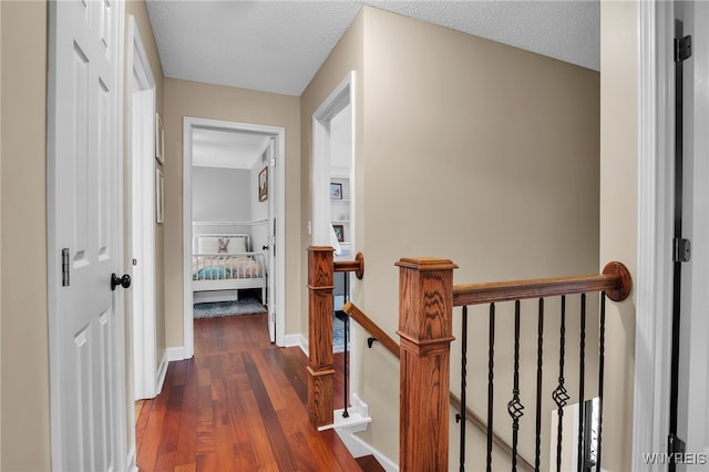 9210 Via Cimato Dr, Clarence, NY 14032 - hallway featuring an upstairs landing, wood finished floors, and a textured ceiling