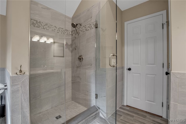 9210 Via Cimato Dr, Clarence, NY 14032 - full bath with a stall shower, tile walls, wood finished floors, and wainscoting