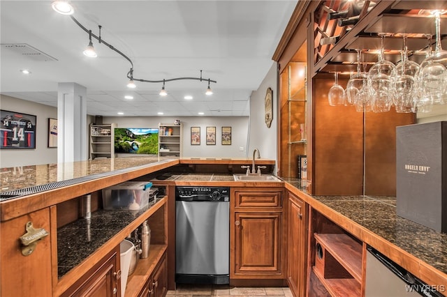 9210 Via Cimato Dr, Clarence, NY 14032 - kitchen featuring stainless steel dishwasher, tile counters, brown cabinetry, and track lighting