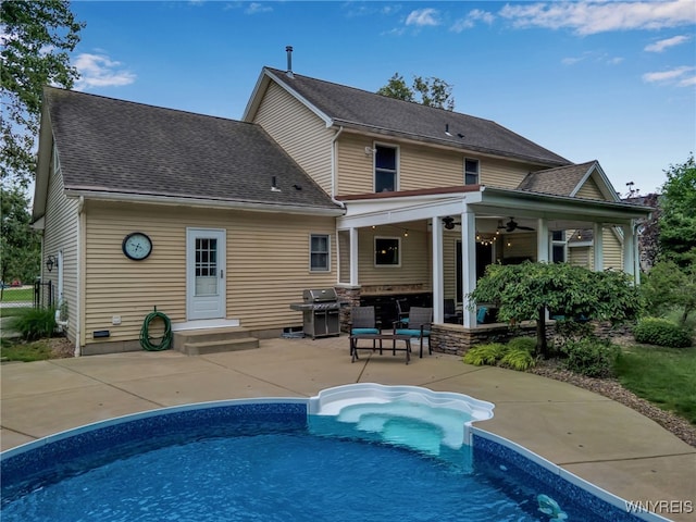 9210 Via Cimato Dr, Clarence, NY 14032 - rear view of house featuring a patio, an outdoor pool, a ceiling fan, and a shingled roof
