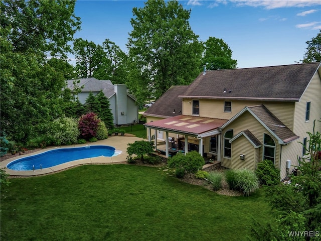 9210 Via Cimato Dr, Clarence, NY 14032 - rear view of house featuring a yard, an outdoor pool, a patio, and a metal roof
