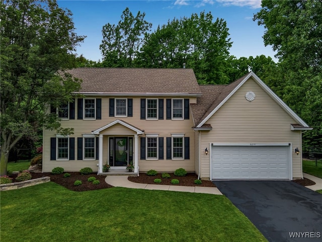 9210 Via Cimato Dr, Clarence, NY 14032 - colonial home with driveway, an attached garage, a front lawn, and roof with shingles