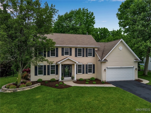 9210 Via Cimato Dr, Clarence, NY 14032 - colonial inspired home with asphalt driveway, a front lawn, a shingled roof, and an attached garage