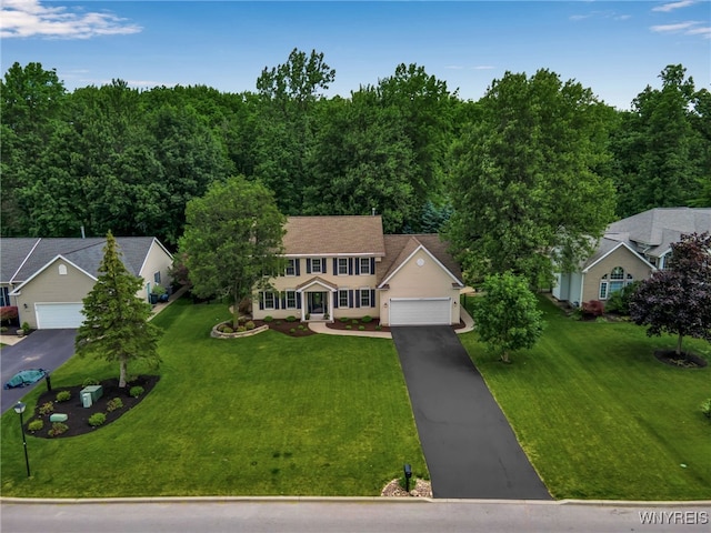 9210 Via Cimato Dr, Clarence, NY 14032 - view of front of house with driveway, a front lawn, and a garage