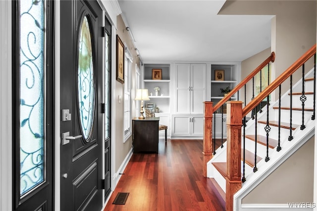 9210 Via Cimato Dr, Clarence, NY 14032 - entryway with dark wood-style floors and stairway