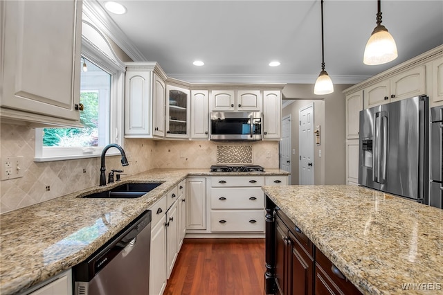 9210 Via Cimato Dr, Clarence, NY 14032 - kitchen featuring appliances with stainless steel finishes, pendant lighting, light stone counters, ornamental molding, and dark wood-type flooring